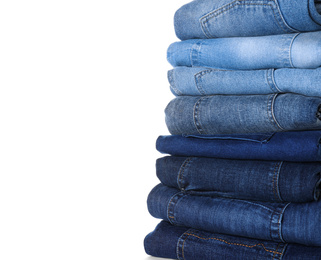 Stack of different jeans isolated on white