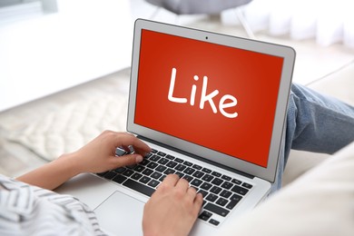 Woman using laptop with word Like on screen indoors, closeup