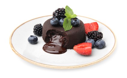 Photo of Plate with delicious chocolate fondant, berries and mint isolated on white