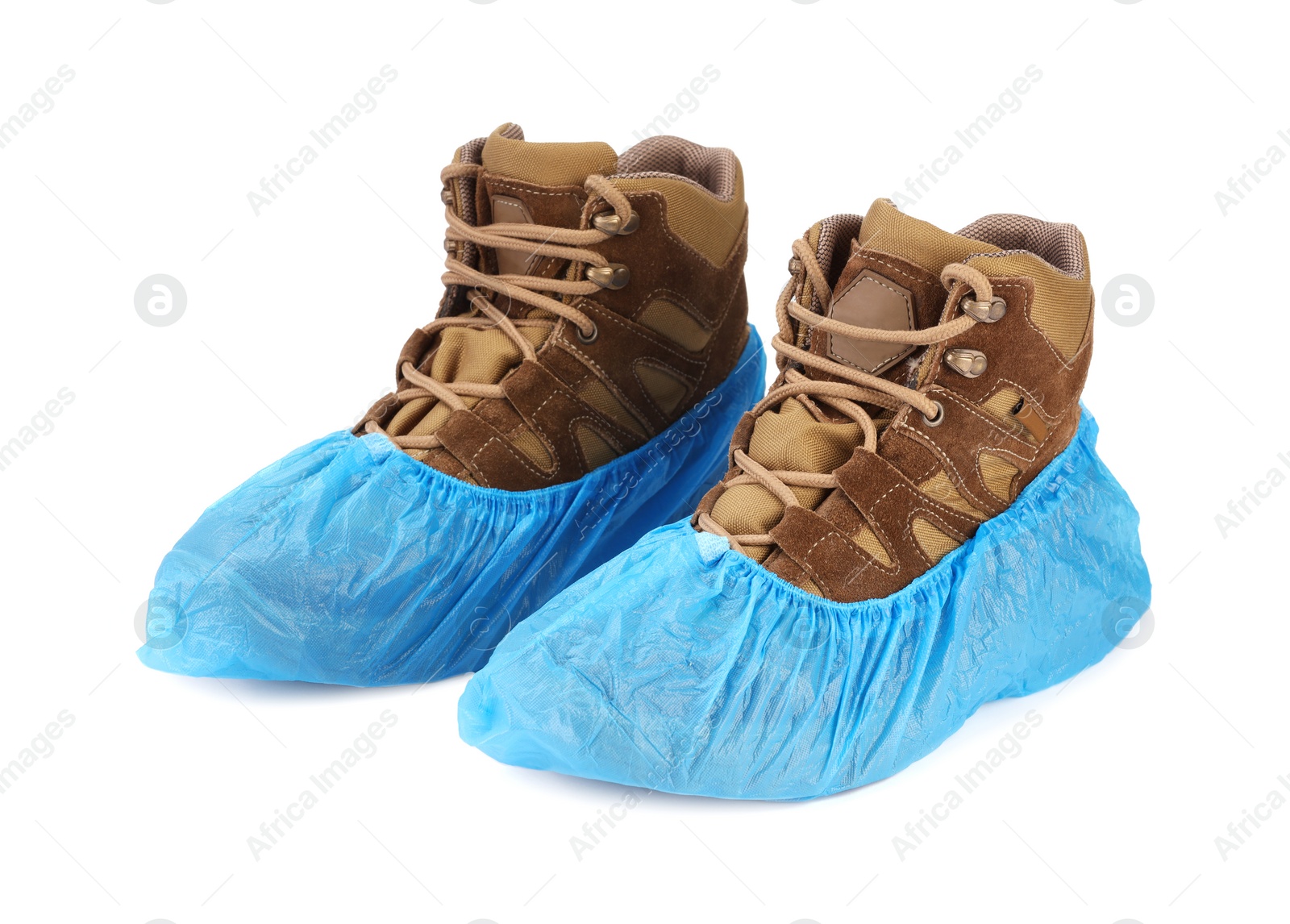 Photo of Boots in blue shoe covers isolated on white