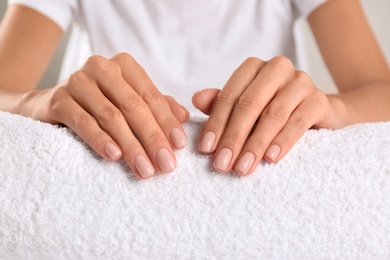 Closeup view of beautiful female hands on towel. Spa treatment