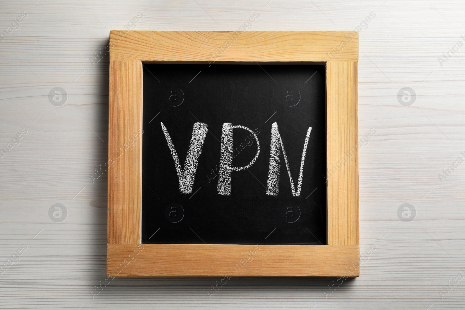 Photo of Chalkboard with acronym VPN on wooden table, top view