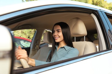 Photo of Beautiful young driver sitting in modern car