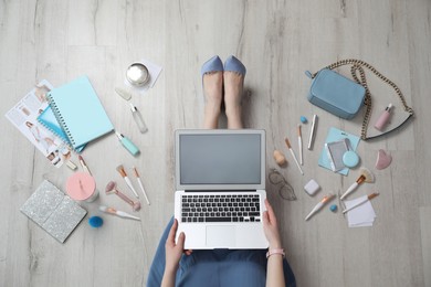 Photo of Beauty blogger with laptop on floor, top view