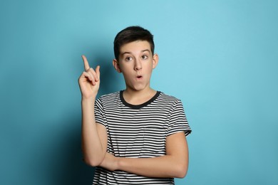 Photo of Emotional teenage boy on light blue background