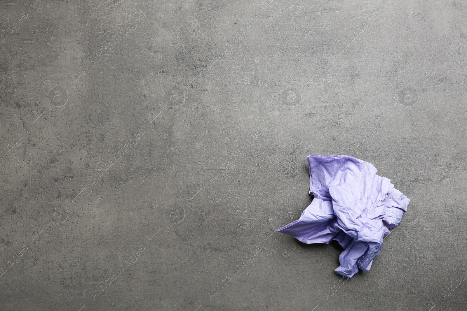 Photo of Crumpled paper napkin and space for text on grey background, top view