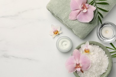 Photo of Flat lay composition with different spa products and flowers on white marble table. Space for text