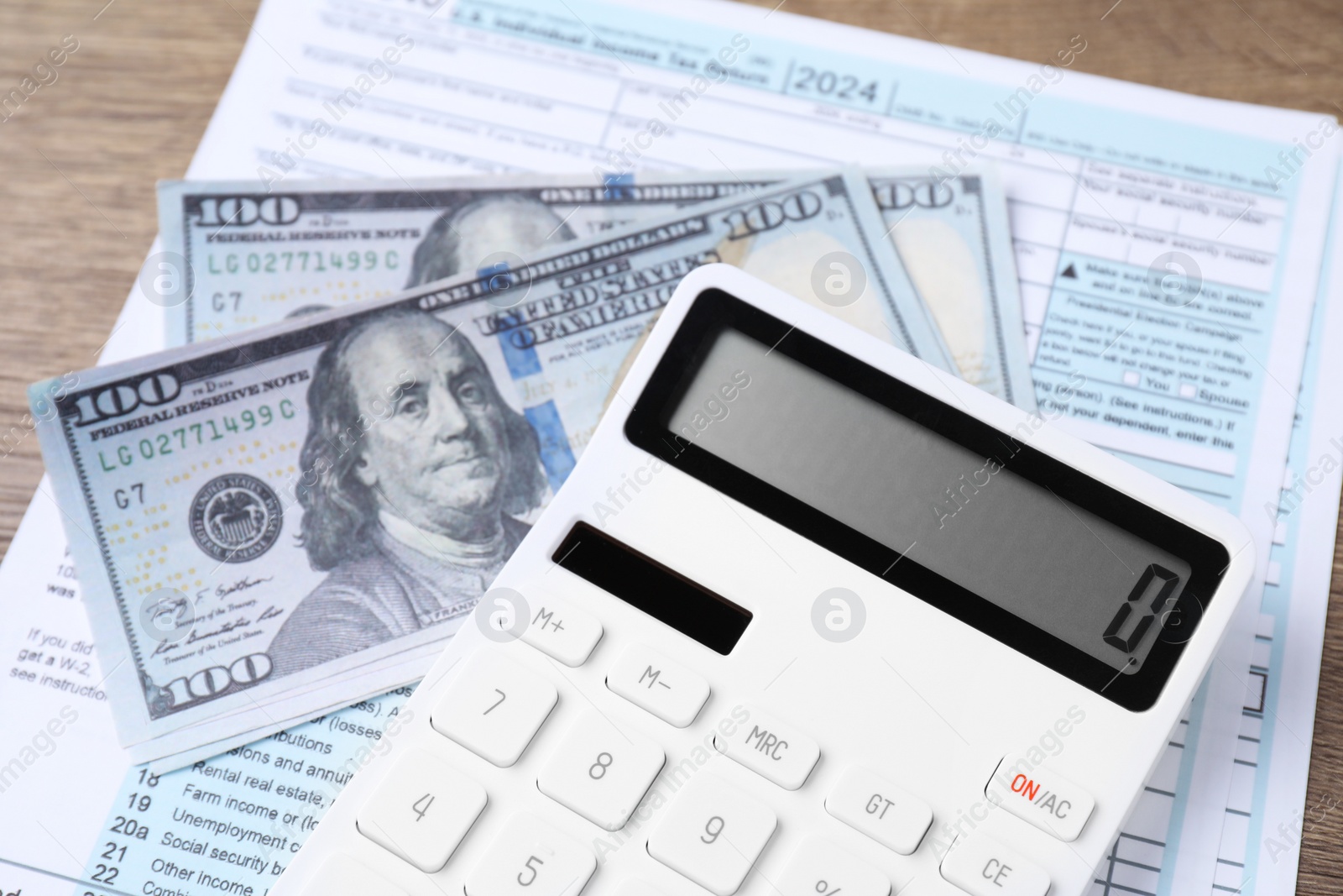 Photo of Tax accounting. Calculator, document and dollar banknotes on table, closeup