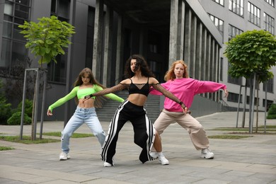 Beautiful young women dancing hip hop outdoors