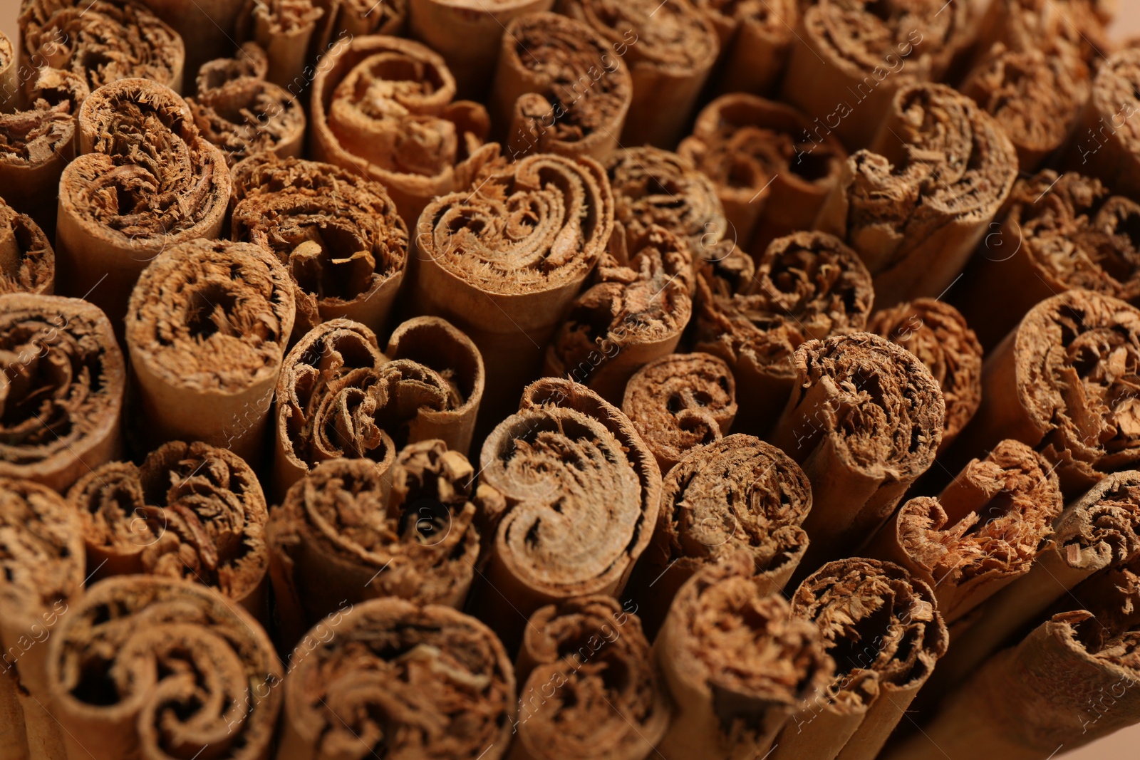 Photo of Aromatic cinnamon sticks as background, closeup view