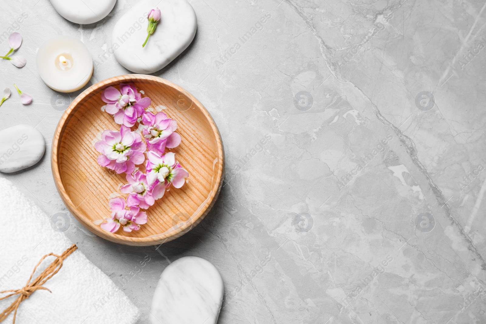 Photo of Flat lay composition with spa stones on light grey marble table, space for text