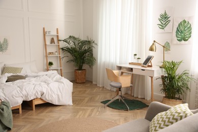 Modern bedroom with beautiful fresh house plants