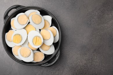 Photo of Fresh hard boiled eggs on brown table, top view. Space for text