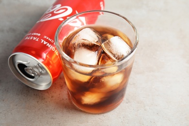 MYKOLAIV, UKRAINE - NOVEMBER 15, 2018: Glass and can with Coca Cola on table, closeup