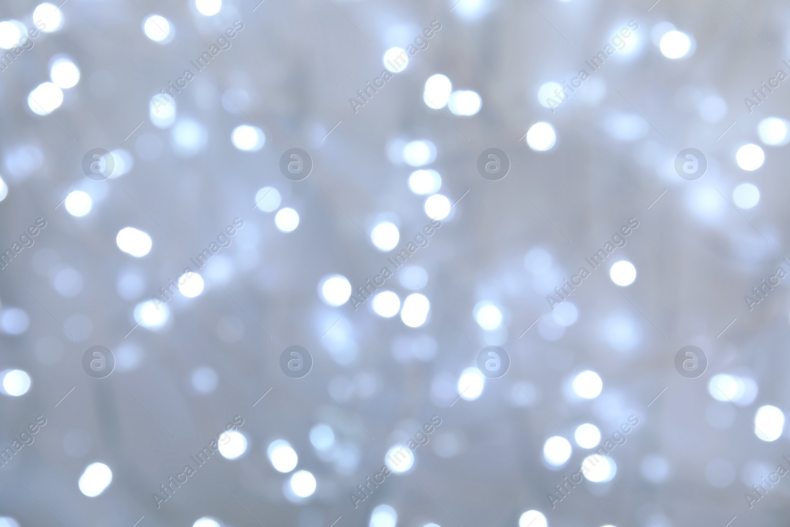 Photo of Blurred view of glowing Christmas lights as background