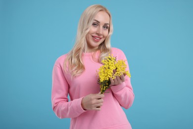 Photo of Beautiful young woman on light blue background