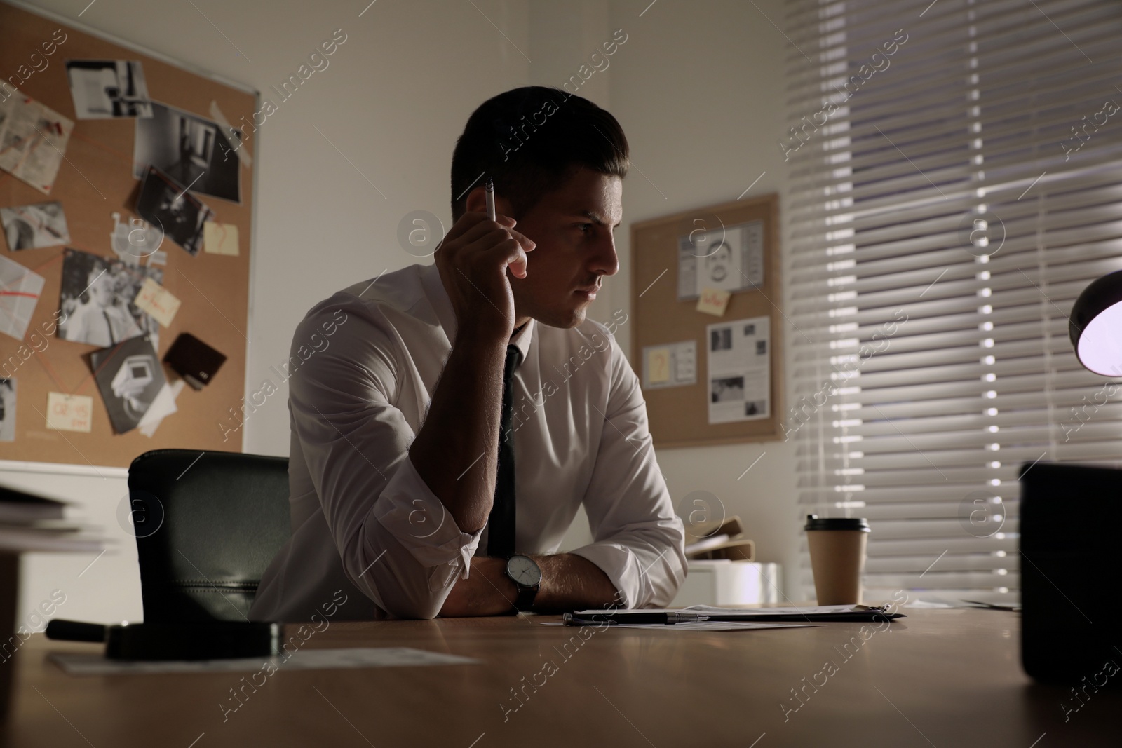 Photo of Detective working at desk in his office