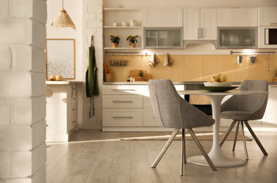 Photo of Modern kitchen interior with stylish white furniture. Space for text