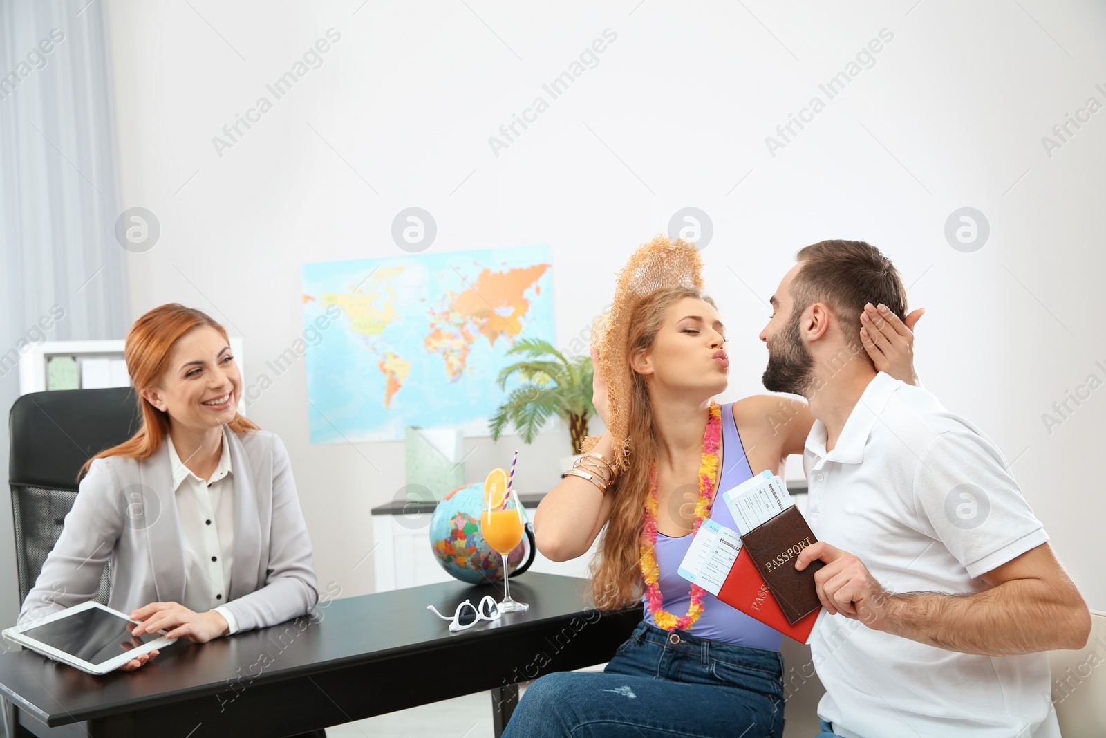 Photo of Beautiful young couple visiting travel agency office