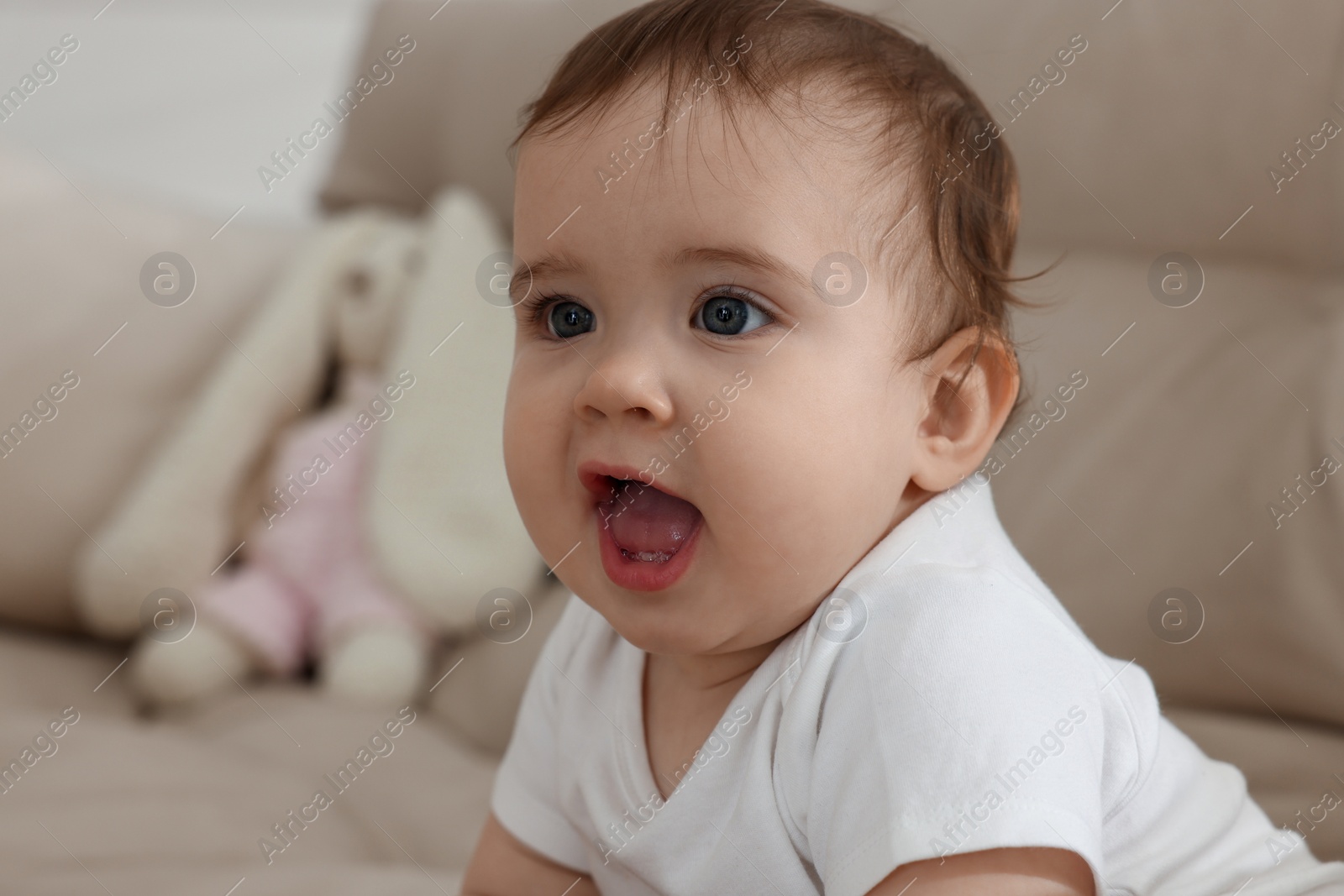 Photo of Cute little baby on sofa at home