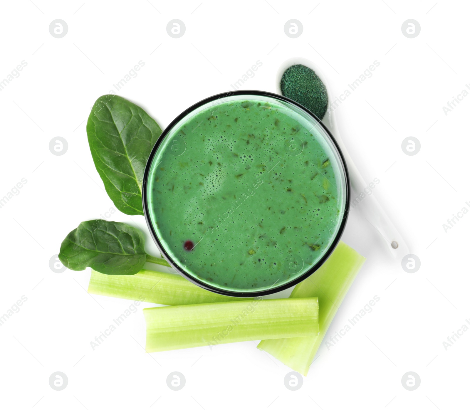 Photo of Glass of spirulina smoothie, powder, spinach and celery on white background, top view