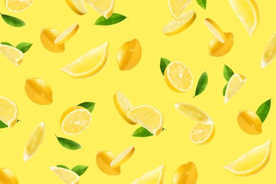 Image of Fresh ripe lemons and green leaves flying on yellow background
