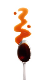 Photo of Traditional soy sauce and spoon on white background, top view