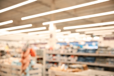 Photo of Blurred view of modern shopping mall interior