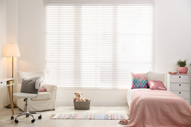 Photo of Modern child room interior with comfortable bed