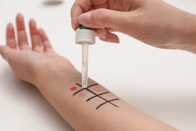 Photo of Patient undergoing skin allergy test at light table, closeup