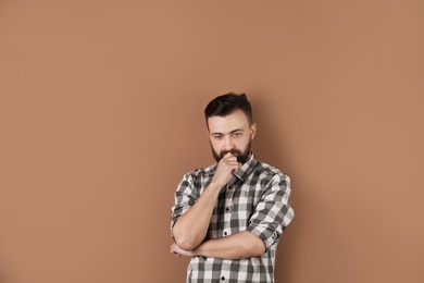 Photo of Portrait of handsome bearded man on color background