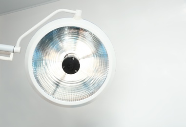 Powerful surgical lamp in modern operating room. Space for text