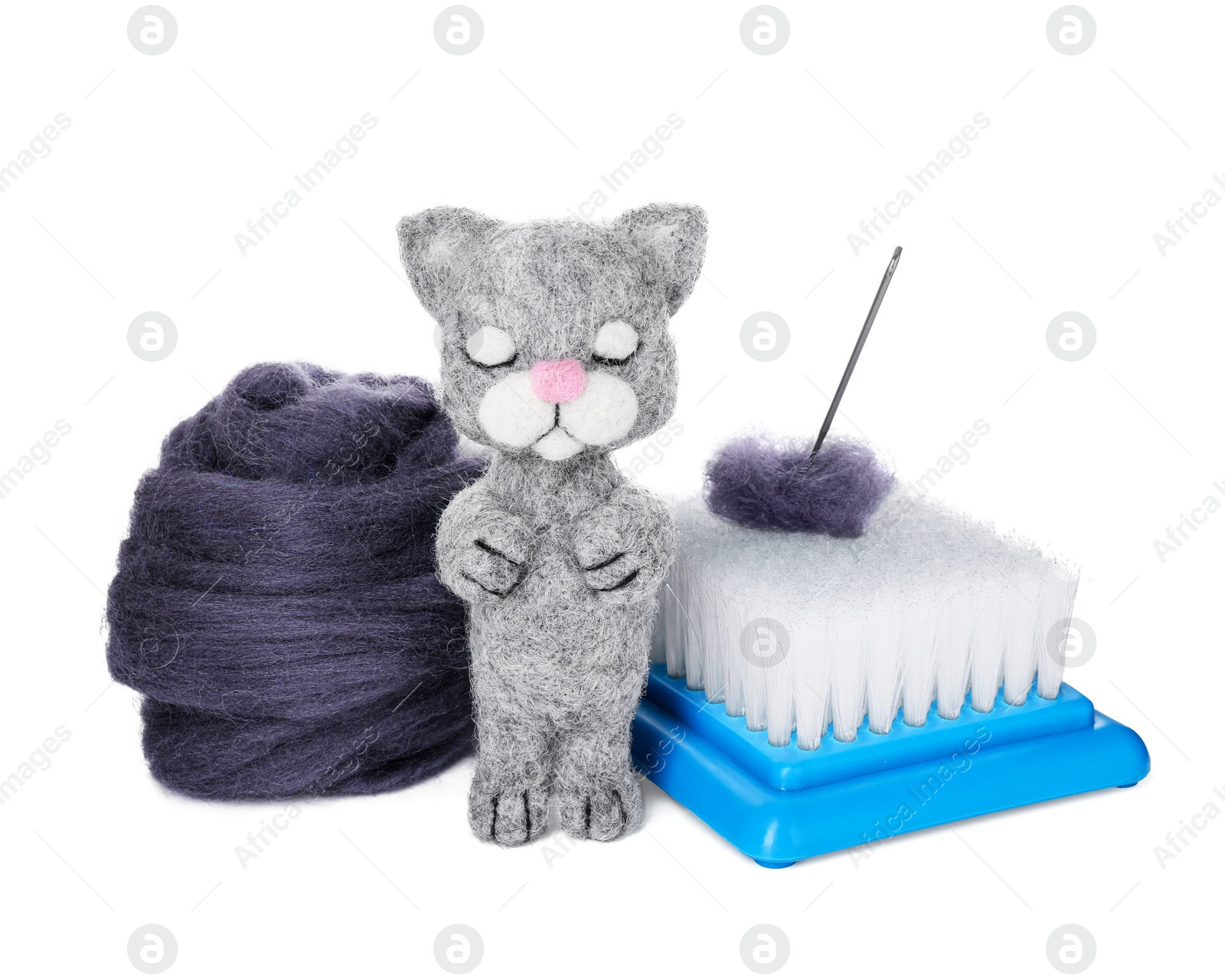 Photo of Needle felted cat, wool and tools isolated on white