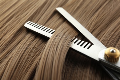 Thinning scissors on light brown hair, closeup. Hairdresser service