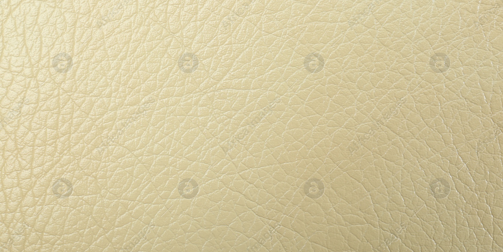 Photo of Texture of beige leather as background, closeup