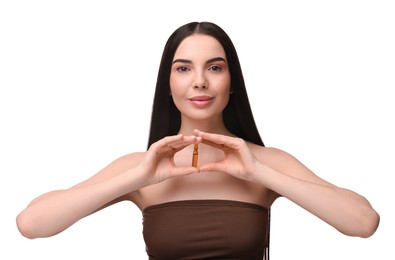 Photo of Beautiful young woman holding skincare ampoule on white background