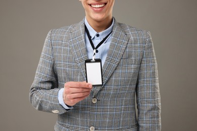 Photo of Man with blank badge on grey background, closeup