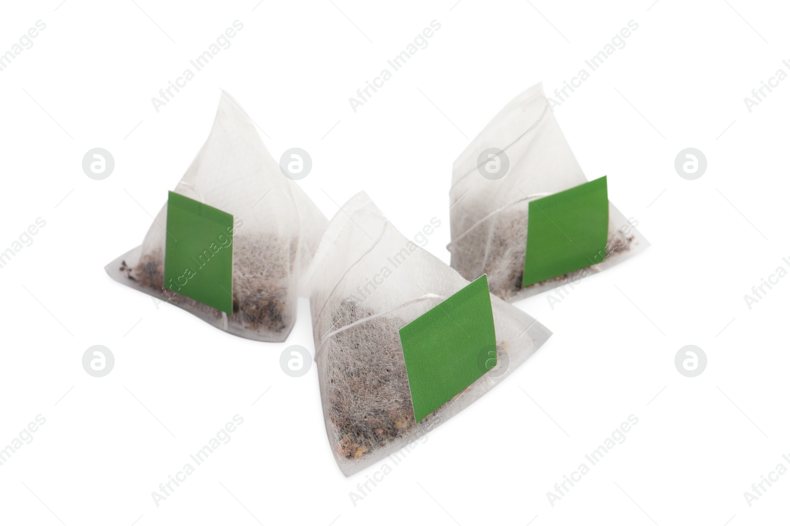 Photo of New pyramid tea bags on white background