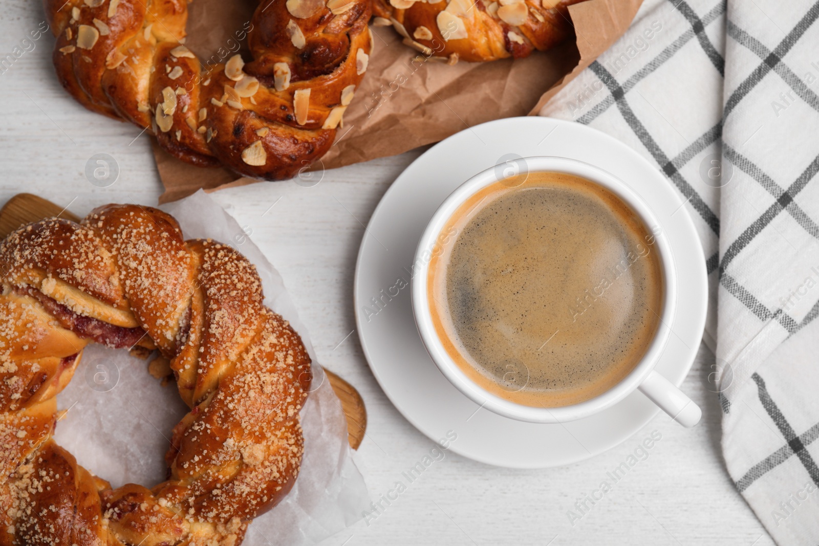 Photo of Delicious pastries and coffee on white wooden table, flat lay