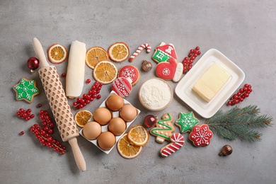 Photo of Flat lay composition with homemade Christmas cookies and ingredients on grey table