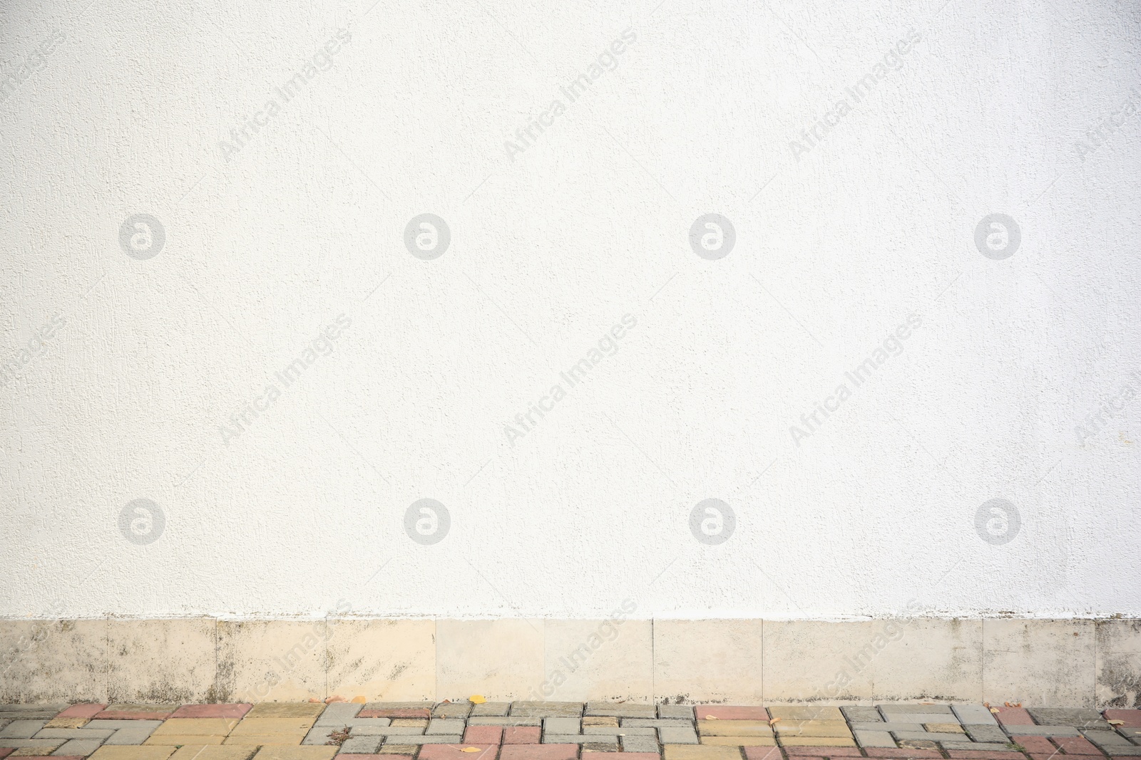 Photo of White stone wall of building outdoors. Exterior design
