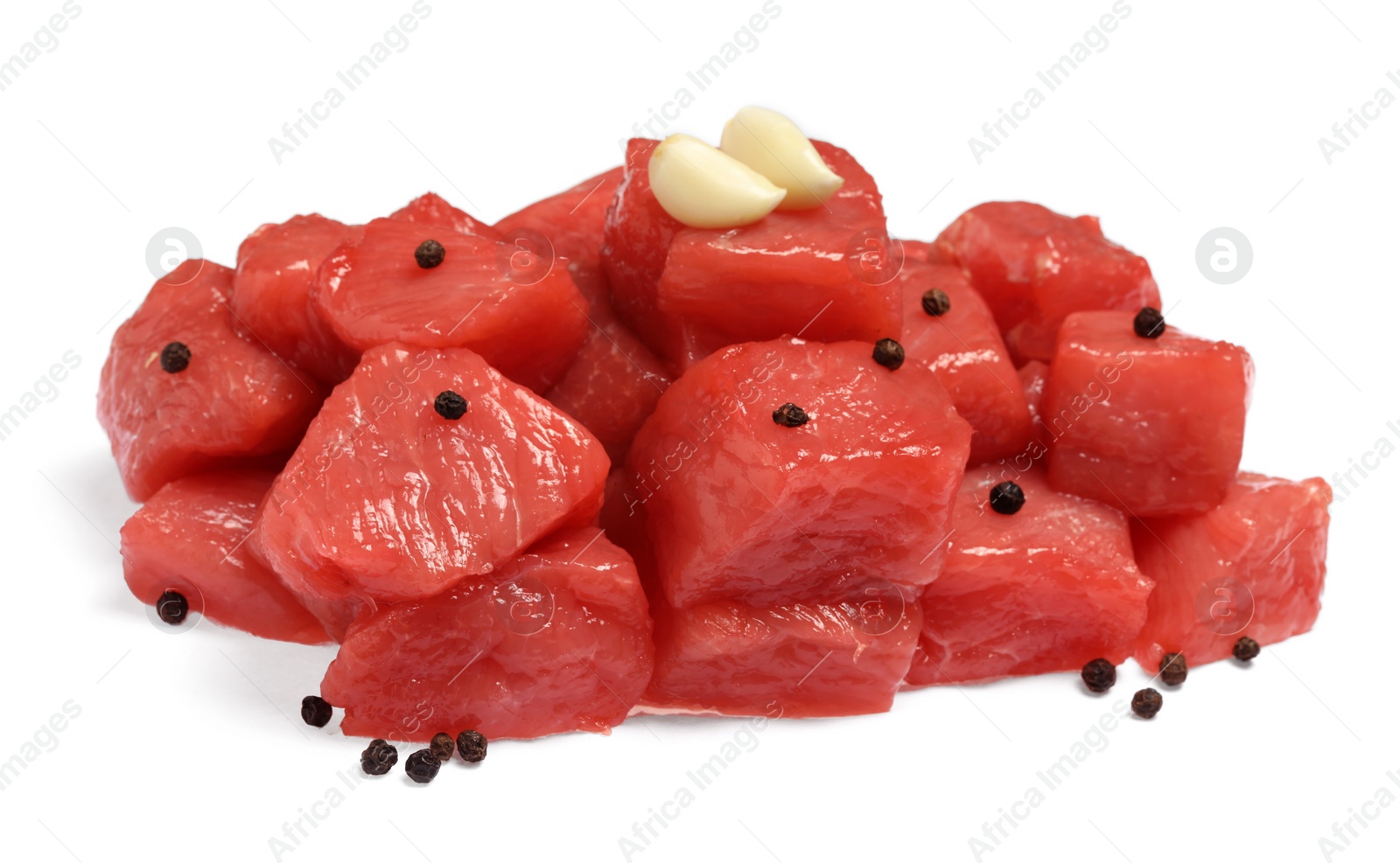 Photo of Pieces of raw beef, peppercorns and garlic isolated on white