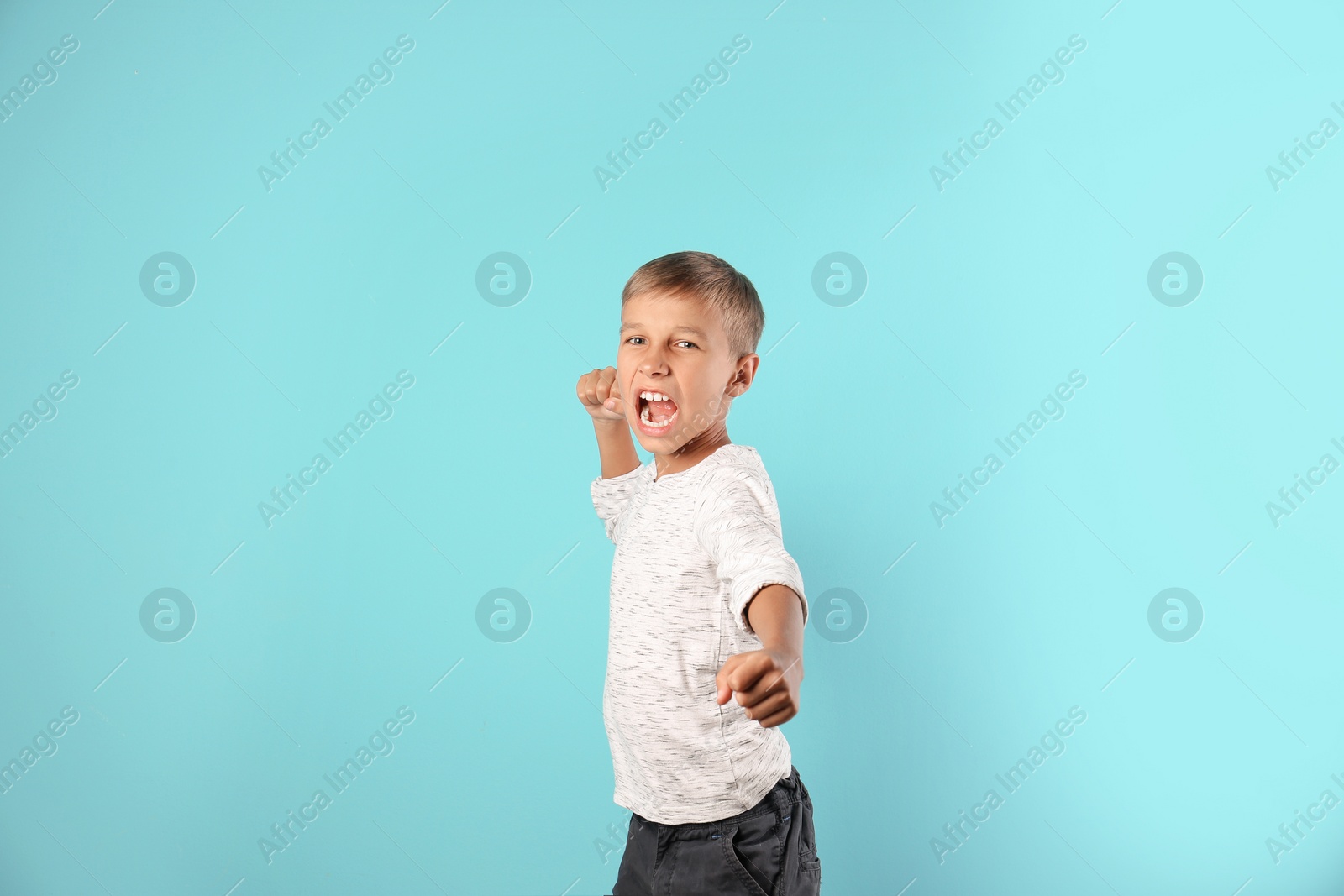 Photo of Adorable little boy in casual clothes on color background