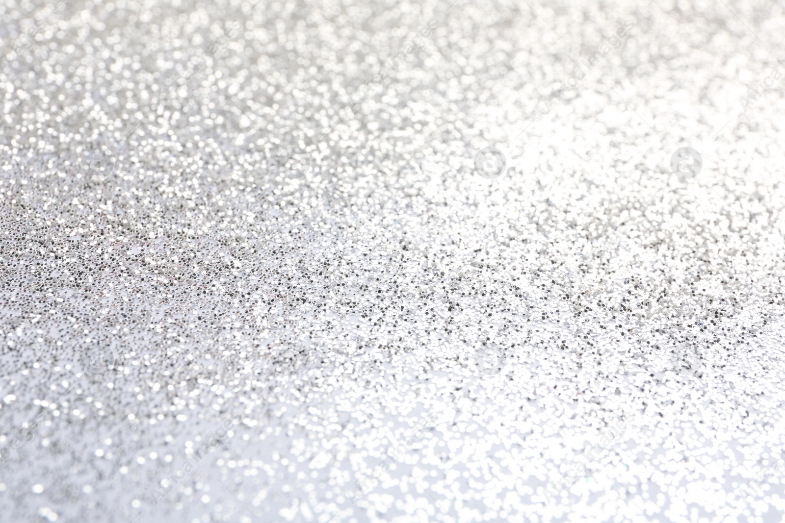 Photo of Closeup view of sparkling silver glitter background