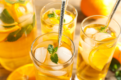 Delicious refreshing drink with orange slices on table, closeup