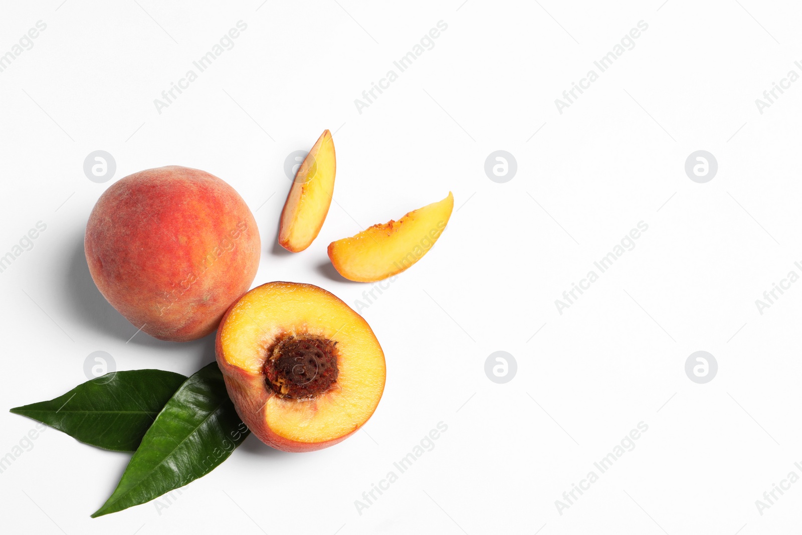 Photo of Delicious juicy peaches and leaves on white background, flat lay. Space for text