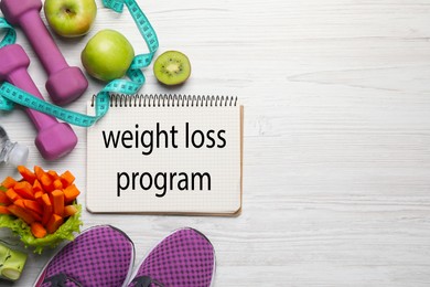 Photo of Weight loss concept. Flat lay composition with notebook, sneakers and different products on white wooden table, space for text