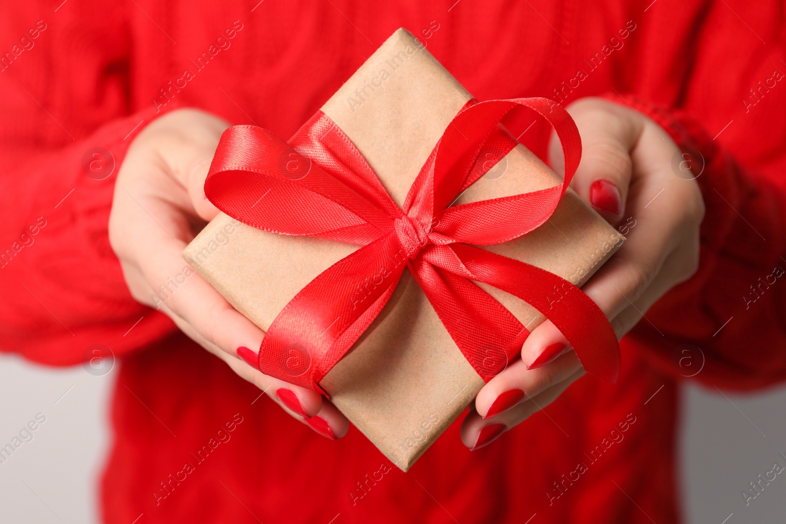 Photo of Christmas present. Woman holding gift box, closeup