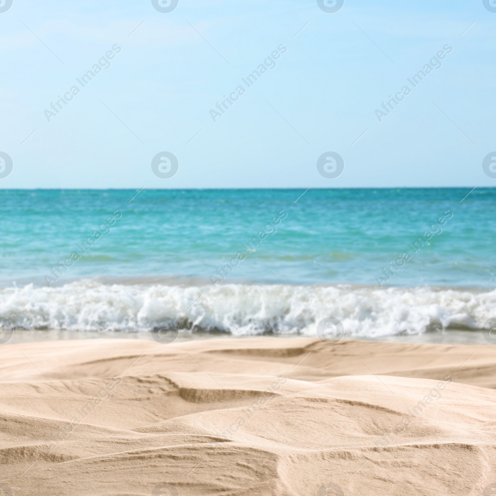 Image of Ocean waves rolling on sandy beach, closeup view