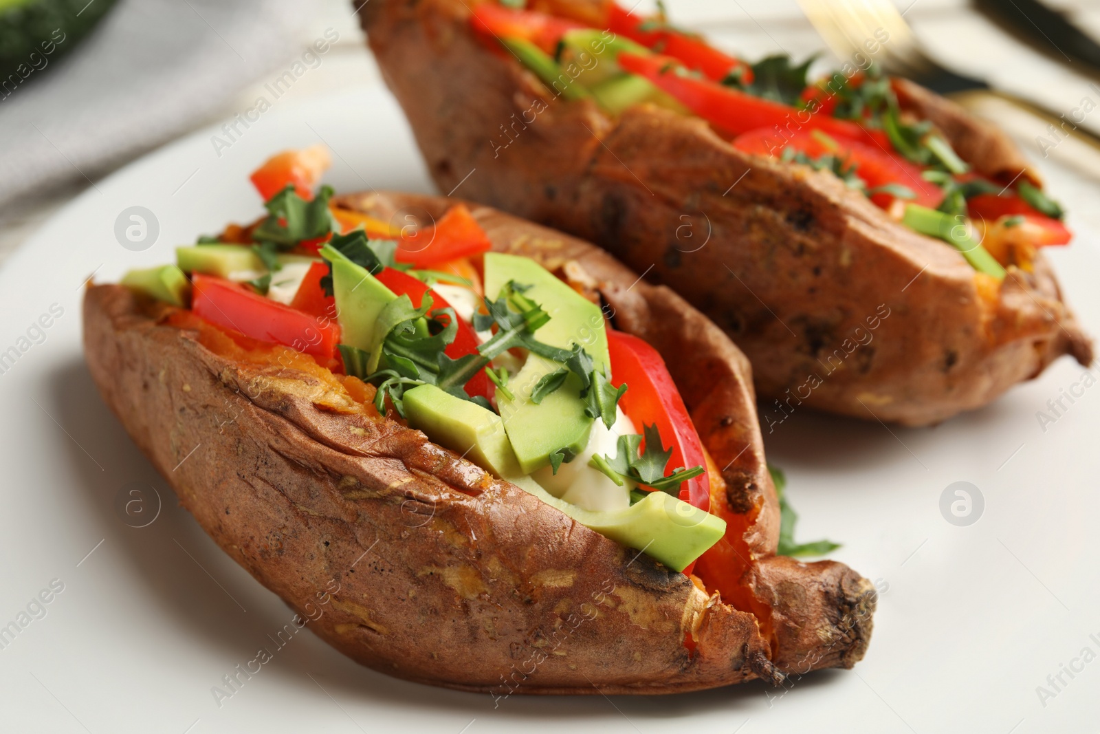 Photo of Stuffed sweet potatoes served on plate, closeup